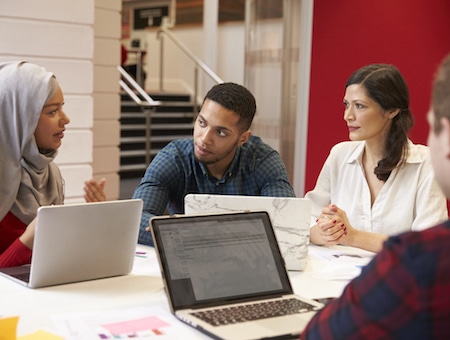 Group Of Students Meeting For Tutorial With Teacher