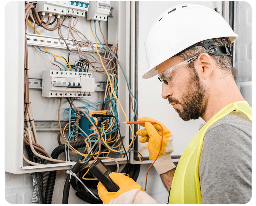 Electrician checking electrical box with multimeter in corridor