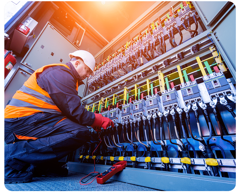 Worker uses clamp meter to measure the current of electrical wires