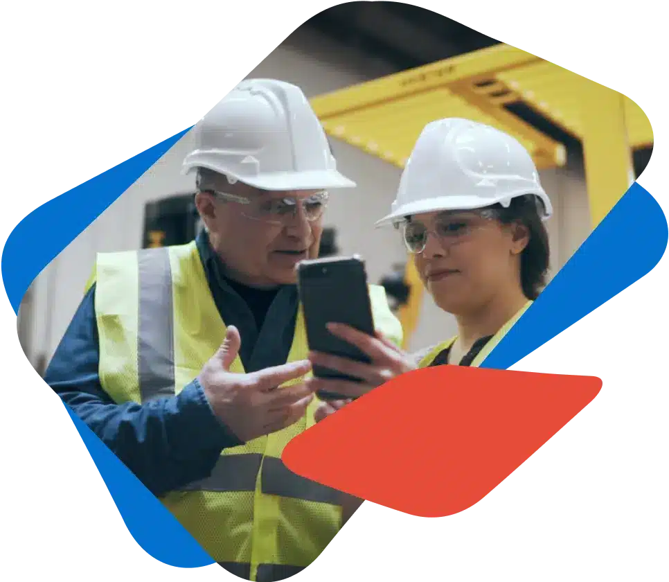 A supervisor shows an employee their behaviour-based safety management system on a mobile device